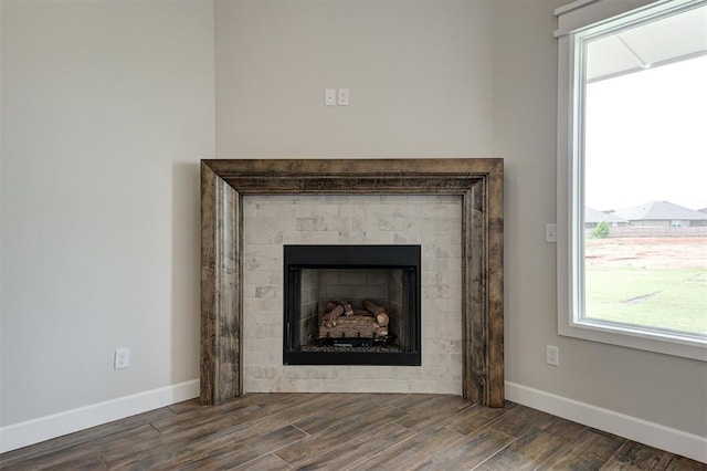 10412 SW 49th St, Mustang, OK 73064 - detailed view of baseboards, wood finished floors, and a fireplace