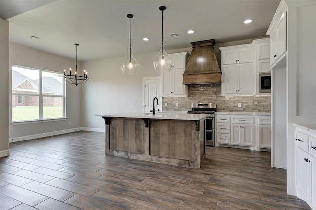 10412 SW 49th St, Mustang, OK 73064 - kitchen with stainless steel stove, custom exhaust hood, tasteful backsplash, light countertops, and recessed lighting
