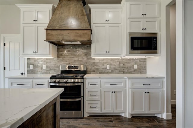 10412 SW 49th St, Mustang, OK 73064 - kitchen with premium range hood, stainless steel gas stove, built in microwave, dark wood-style floors, and tasteful backsplash