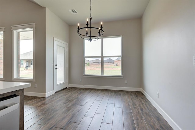 10412 SW 49th St, Mustang, OK 73064 - unfurnished dining area featuring a chandelier, dark wood-style floors, plenty of natural light, and baseboards