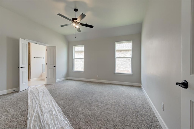 10412 SW 49th St, Mustang, OK 73064 - unfurnished bedroom with carpet floors, lofted ceiling, baseboards, ensuite bath, and a ceiling fan