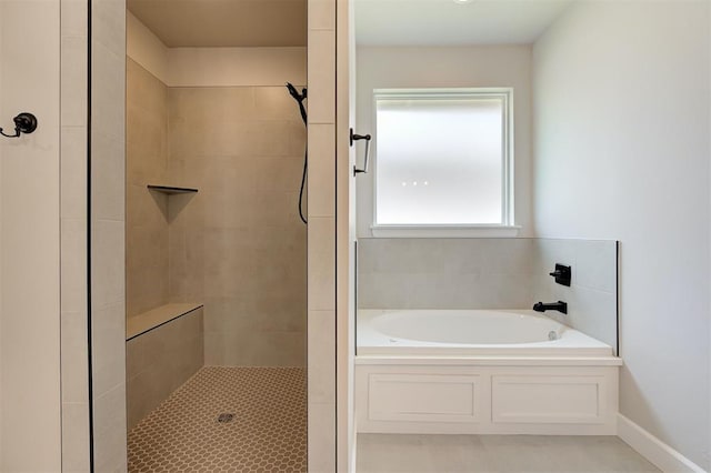 10412 SW 49th St, Mustang, OK 73064 - bathroom featuring a garden tub, a tile shower, tile patterned floors, and baseboards