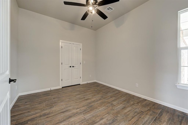 10412 SW 49th St, Mustang, OK 73064 - spare room featuring dark wood-style floors, a ceiling fan, and baseboards