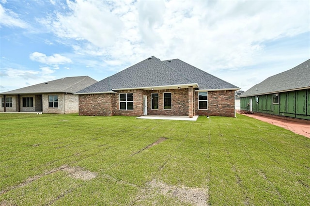 10412 SW 49th St, Mustang, OK 73064 - rear view of property featuring a patio area, a shingled roof, a lawn, and brick siding