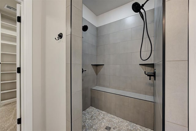 10421 SW 50th St, Mustang, OK 73064 - bathroom featuring a tile shower and a walk in closet