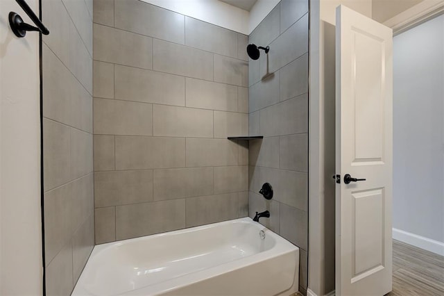 10421 SW 50th St, Mustang, OK 73064 - bathroom featuring shower / washtub combination and wood finished floors