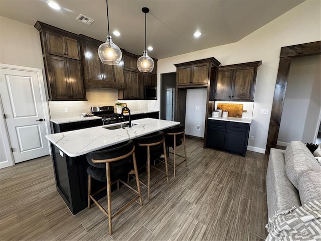 10421 SW 50th St, Mustang, OK 73064 - kitchen with backsplash, dark wood-type flooring, dark brown cabinetry, appliances with stainless steel finishes, and recessed lighting