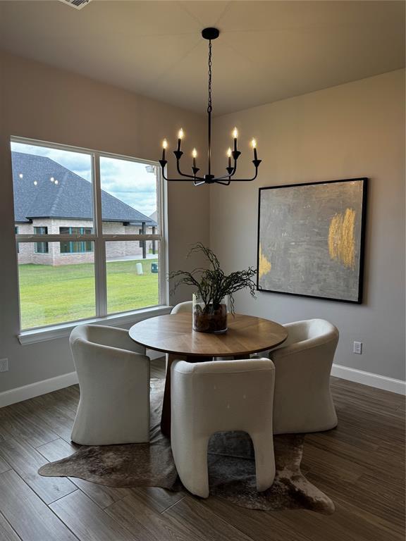 10421 SW 50th St, Mustang, OK 73064 - dining room with a chandelier and wood finished floors