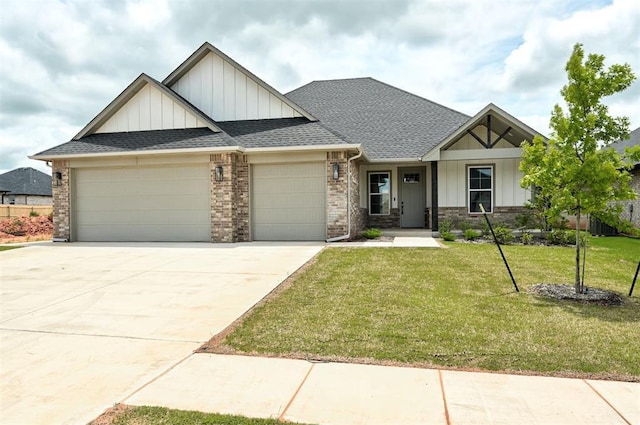 10440 SW 50th St, Mustang, OK 73064 - view of front of property with board and batten siding, a garage, a front lawn, and a shingled roof