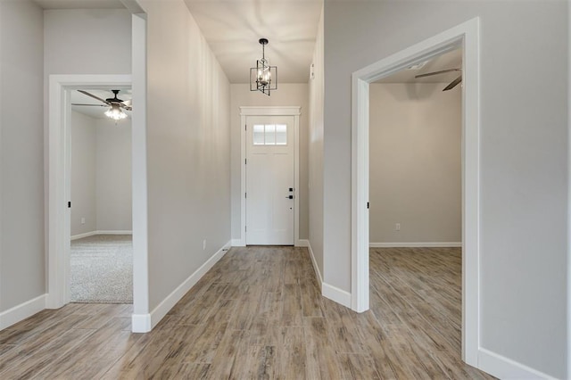 10440 SW 50th St, Mustang, OK 73064 - foyer with light wood-style flooring, ceiling fan, baseboards, and a chandelier
