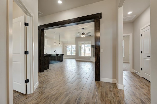 10440 SW 50th St, Mustang, OK 73064 - corridor featuring wood finished floors, baseboards, and recessed lighting