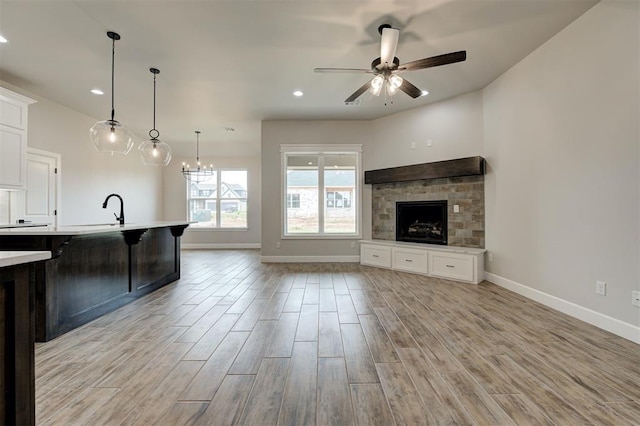 10440 SW 50th St, Mustang, OK 73064 - unfurnished living room with baseboards, light wood finished floors, a ceiling fan, a sink, and recessed lighting
