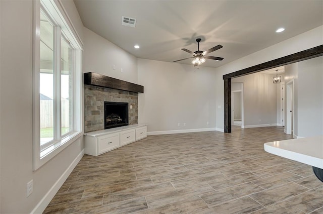 10440 SW 50th St, Mustang, OK 73064 - unfurnished living room with ceiling fan, a stone fireplace, baseboards, and recessed lighting
