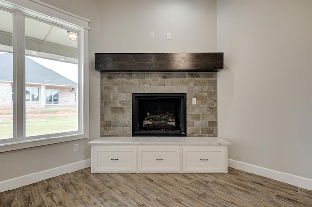 10440 SW 50th St, Mustang, OK 73064 - detailed view of baseboards, wood finished floors, and a fireplace
