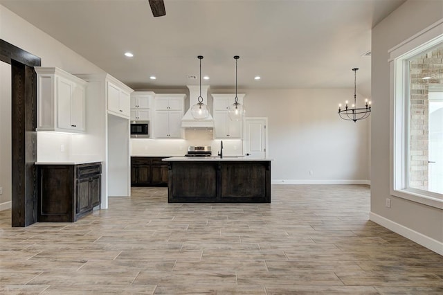 10440 SW 50th St, Mustang, OK 73064 - kitchen with stainless steel appliances, custom exhaust hood, white cabinetry, baseboards, and recessed lighting