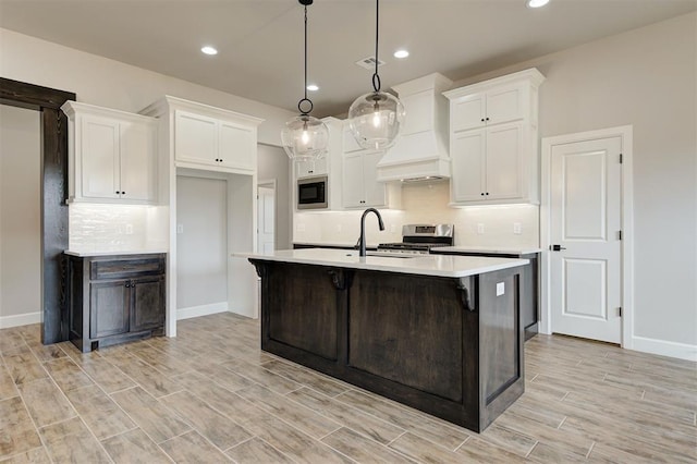 10440 SW 50th St, Mustang, OK 73064 - kitchen featuring stainless steel stove, light countertops, baseboards, white cabinetry, and recessed lighting