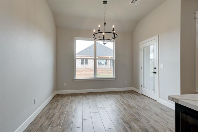 10440 SW 50th St, Mustang, OK 73064 - unfurnished dining area with a chandelier, wood finished floors, vaulted ceiling, and baseboards