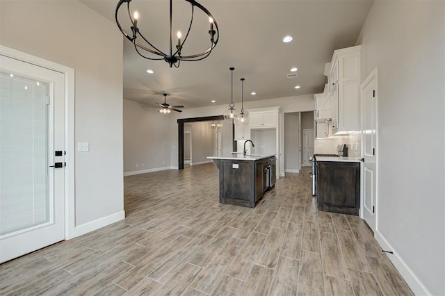 10440 SW 50th St, Mustang, OK 73064 - kitchen featuring open floor plan, a chandelier, recessed lighting, light wood-style flooring, and white cabinetry