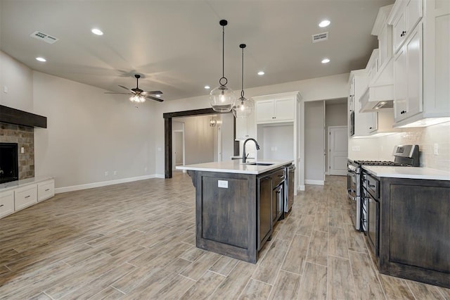 10440 SW 50th St, Mustang, OK 73064 - kitchen featuring stainless steel appliances, a sink, dark brown cabinetry, ceiling fan, and white cabinetry