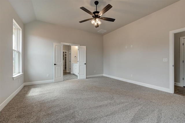 10440 SW 50th St, Mustang, OK 73064 - unfurnished bedroom with carpet, baseboards, lofted ceiling, a ceiling fan, and connected bathroom