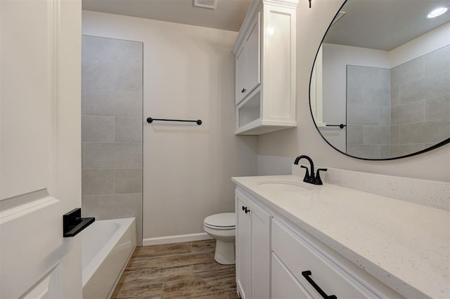 10440 SW 50th St, Mustang, OK 73064 - bathroom with vanity, toilet, wood finished floors, and baseboards