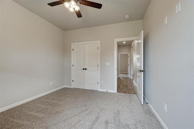 10440 SW 50th St, Mustang, OK 73064 - unfurnished bedroom featuring carpet flooring, baseboards, a closet, and a ceiling fan