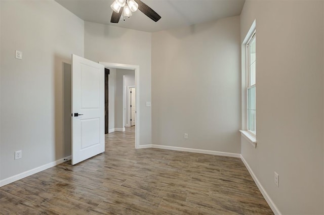 10440 SW 50th St, Mustang, OK 73064 - unfurnished room featuring ceiling fan, wood finished floors, and baseboards