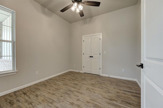 10440 SW 50th St, Mustang, OK 73064 - unfurnished room featuring ceiling fan, wood finished floors, baseboards, and vaulted ceiling