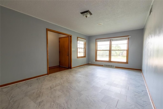 3701 NW 18th St, Oklahoma City, OK 73107 - spare room featuring a textured ceiling and baseboards