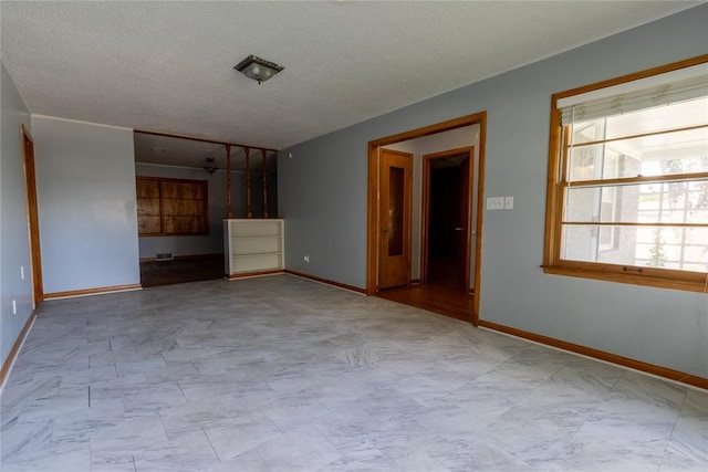 3701 NW 18th St, Oklahoma City, OK 73107 - unfurnished living room with baseboards and a textured ceiling