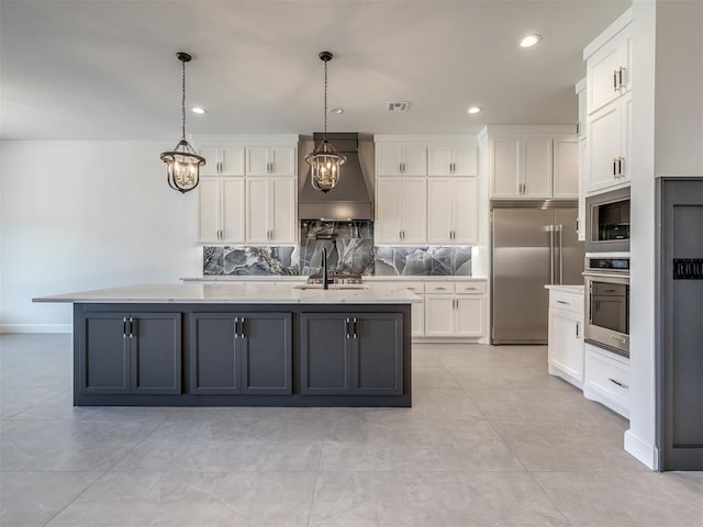 1116 Gateway Bridge Rd, Edmond, OK 73034 - kitchen featuring custom range hood, appliances with stainless steel finishes, white cabinetry, a sink, and decorative backsplash