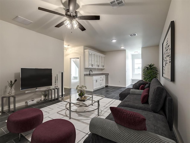 1116 Gateway Bridge Rd, Edmond, OK 73034 - living room with ceiling fan, dark tile patterned floors, and baseboards