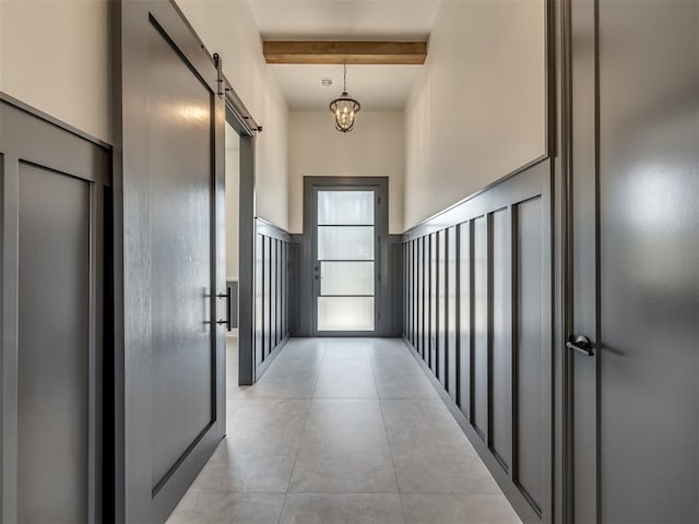 1116 Gateway Bridge Rd, Edmond, OK 73034 - hallway with a barn door, beamed ceiling, light tile patterned floors, and a chandelier