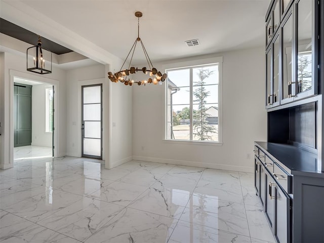 1117 Falls Bridge Ct, Edmond, OK 73034 - unfurnished dining area with baseboards, a chandelier, and light marble finish flooring