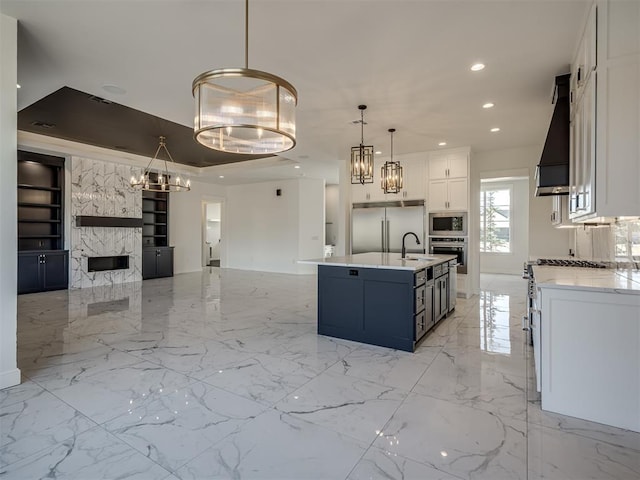 1117 Falls Bridge Ct, Edmond, OK 73034 - kitchen with premium range hood, built in appliances, open floor plan, a sink, and built in features