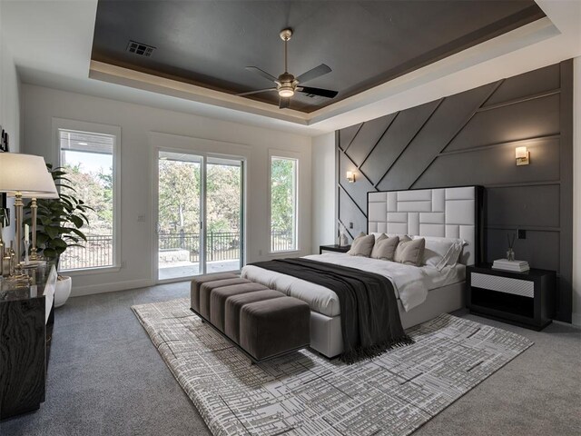1117 Falls Bridge Ct, Edmond, OK 73034 - carpeted bedroom with a raised ceiling, access to outside, a decorative wall, and ceiling fan