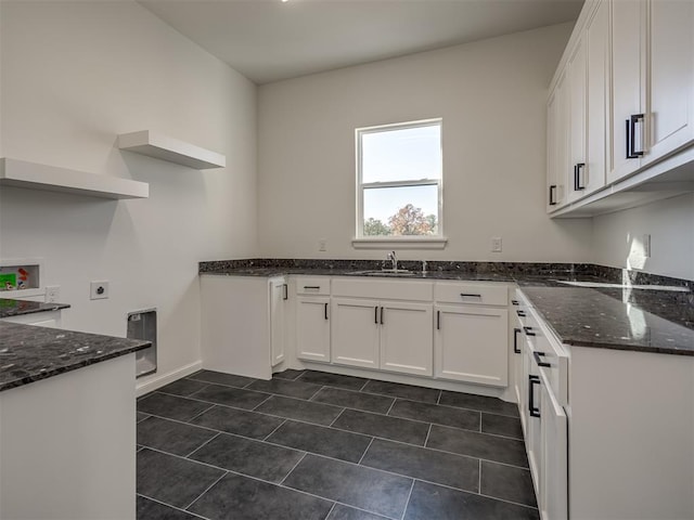 1117 Falls Bridge Ct, Edmond, OK 73034 - kitchen with dark stone counters, a sink, and white cabinets
