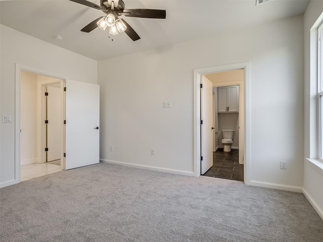 1117 Falls Bridge Ct, Edmond, OK 73034 - unfurnished bedroom featuring carpet flooring, baseboards, ensuite bath, and a ceiling fan
