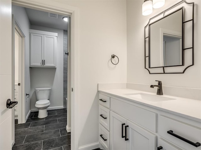 1117 Falls Bridge Ct, Edmond, OK 73034 - bathroom featuring vanity, baseboards, toilet, and tile patterned flooring