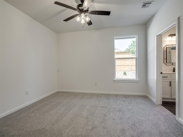 1117 Falls Bridge Ct, Edmond, OK 73034 - carpeted empty room featuring a ceiling fan, baseboards, and a sink