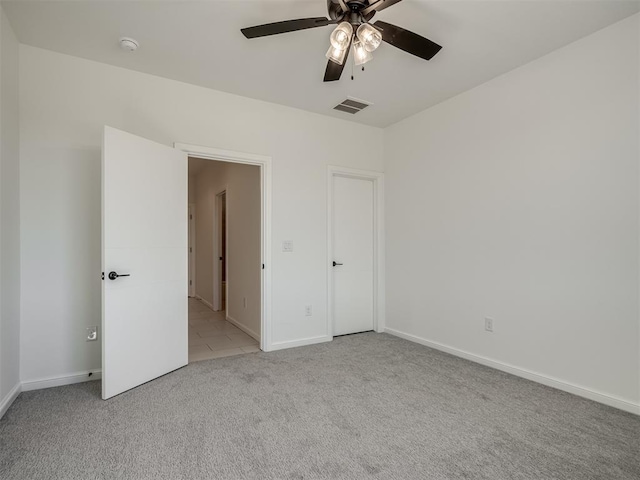 1117 Falls Bridge Ct, Edmond, OK 73034 - unfurnished bedroom with light carpet, baseboards, and a ceiling fan