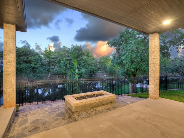 1117 Falls Bridge Ct, Edmond, OK 73034 - view of patio / terrace featuring a fire pit and view of scattered trees
