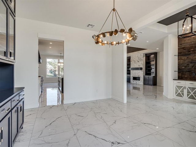 1117 Falls Bridge Ct, Edmond, OK 73034 - unfurnished dining area with a chandelier, baseboards, recessed lighting, and light marble finish flooring