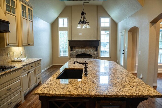 3176 E 146th Pl, Bixby, OK 74008 - kitchen with a sink, extractor fan, light stone countertops, dark wood finished floors, and high vaulted ceiling
