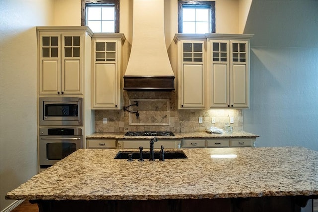 3176 E 146th Pl, Bixby, OK 74008 - kitchen featuring stainless steel appliances, a sink, an island with sink, and backsplash