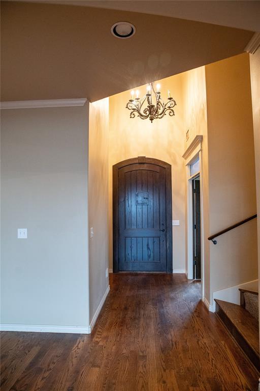 3176 E 146th Pl, Bixby, OK 74008 - foyer with a chandelier, wood finished floors, stairs, and baseboards