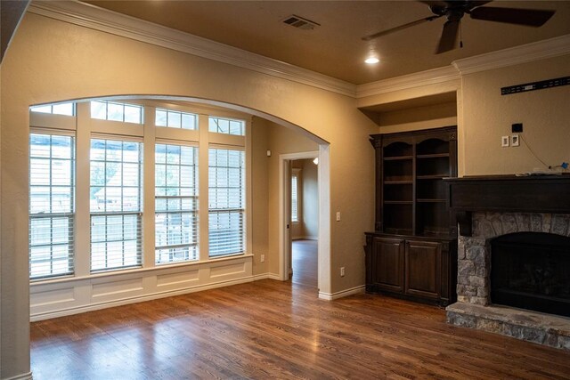 3176 E 146th Pl, Bixby, OK 74008 - unfurnished living room featuring ornamental molding, a ceiling fan, dark wood finished floors, healthy amount of natural light, and arched walkways