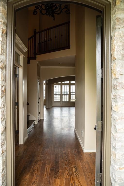 3176 E 146th Pl, Bixby, OK 74008 - hall with arched walkways, baseboards, dark wood finished floors, stairway, and a towering ceiling