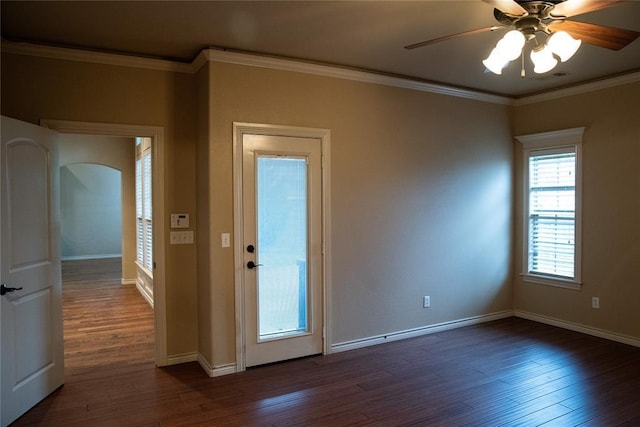 3176 E 146th Pl, Bixby, OK 74008 - spare room with dark wood-style flooring, ceiling fan, baseboards, crown molding, and arched walkways