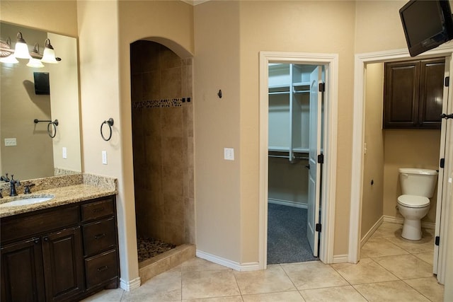 3176 E 146th Pl, Bixby, OK 74008 - full bathroom with vanity, tiled shower, toilet, a spacious closet, and tile patterned flooring
